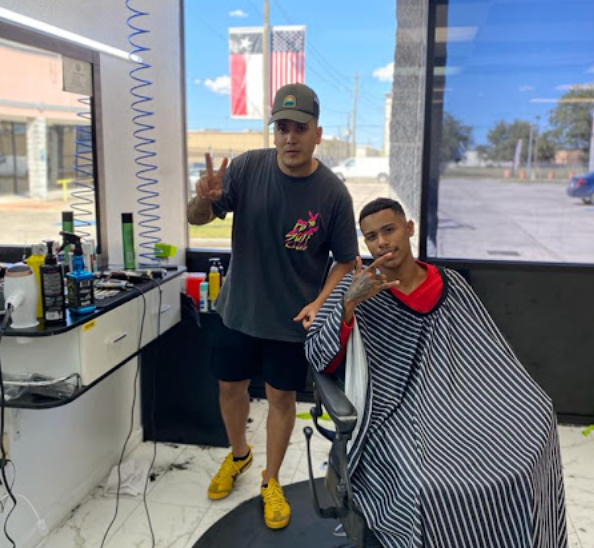 Henry barber with happy client in the chair